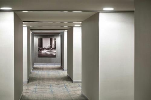 a hallway of a building with white walls at Peachtree Hotel Midtown Atlanta in Atlanta