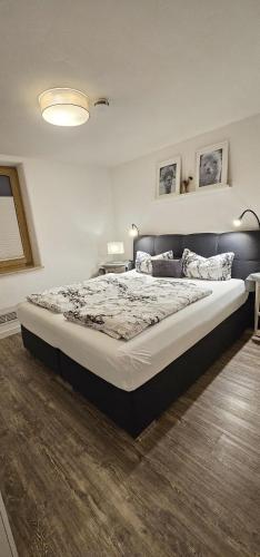 a bedroom with a large bed in a room at Ferienapartment Wilma in Grünsfeld