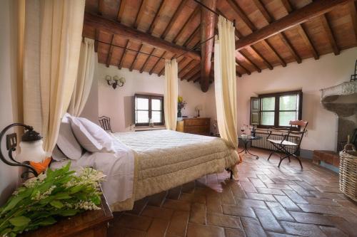 a bedroom with a large bed in a room with wooden ceilings at Terre di Nano in Monticchiello