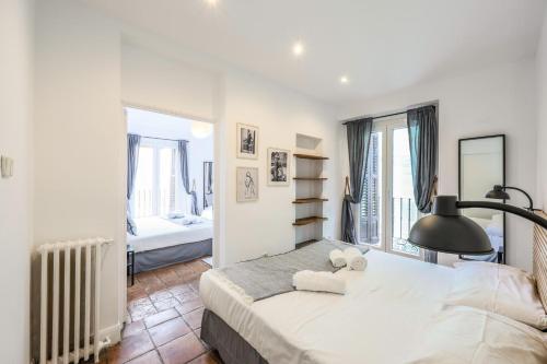 a bedroom with a large bed and a window at Agora Boutique Coliving Madrid in Madrid