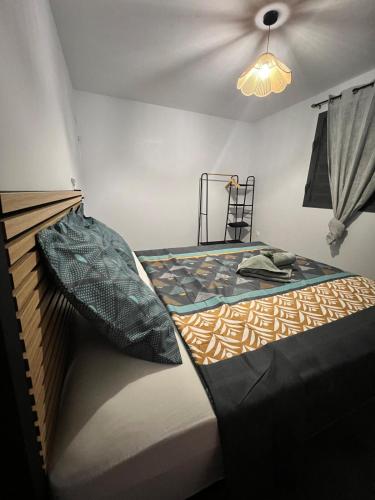 a bedroom with a bed with a pillow on it at Golden palm in Rivière-Pilote