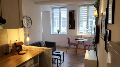 a kitchen and a living room with a table at Tribunal du Beffroi in Douai