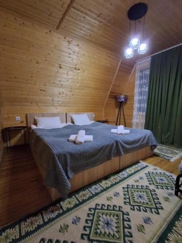 a bedroom with a bed with two towels on it at Cottage Mida in Mestia