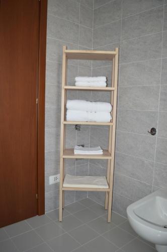 a towel rack in a bathroom with towels at Cologno Centro Apartment in Cologno Monzese