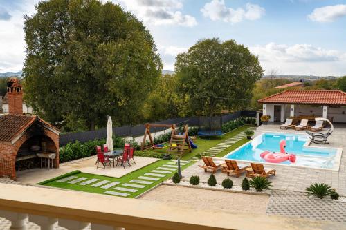 a backyard with a swimming pool and a house at My Dalmatia - Apartment M&N with shared pool in Galovac