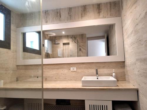 a bathroom with a sink and a mirror at Beachfront Portillo Residence in Las Terrenas