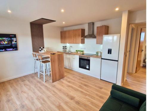 a kitchen with a white refrigerator and a counter at 7 min from Edinburgh Airport 2 Bedroom Apartment in Edinburgh