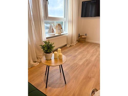 a living room with a table and a window at 7 min from Edinburgh Airport 2 Bedroom Apartment in Edinburgh