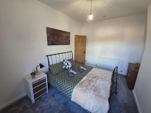 a bedroom with a large bed and a night stand at Magic Stays! in Halton