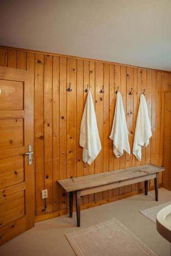 a room with a wooden wall with a bench and towels at Hus Sigritta in Vandans