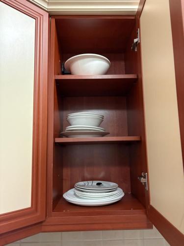 a cabinet with plates and bowls in it at Dolce Casa E K in Strumica