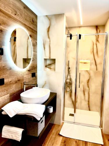 a bathroom with a sink and a shower at Nos Sweet Home in Dimaro