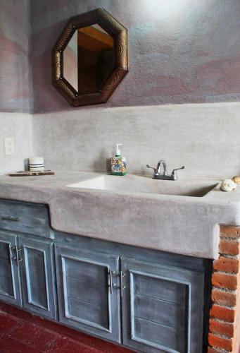 a bathroom with a sink and a mirror at Eco ITZKA Bernal Country House in Bernal