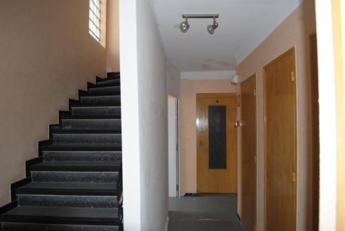 two views of a staircase in a building at Le Logis Charmant in Charmes-sur-Rhône