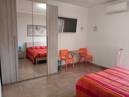a bedroom with a bed and a table and a mirror at B&B SunBeach in San Benedetto del Tronto