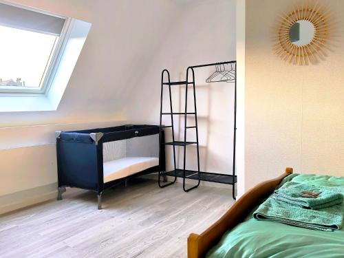 a bedroom with a bunk bed and a ladder at maison cosy proche du port et plage in Grand-Fort-Philippe