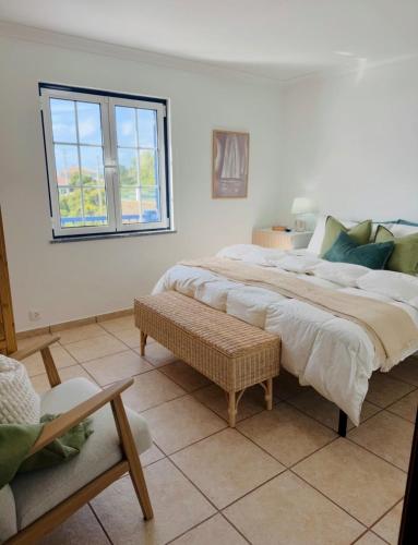a bedroom with a large bed and a window at Island View Retreat in Feteira