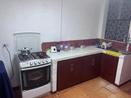 a kitchen with a stove and a counter top at Triple B in Loja