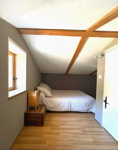 een slaapkamer met een bed en een houten vloer bij Le joli Cabanon in Cabasse