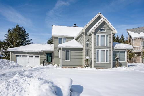 a house with snow in front of it at Cabin & Canoe by Railey Vacations in McHenry