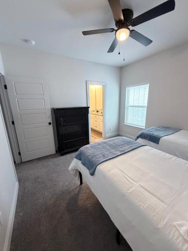 a bedroom with a bed and a ceiling fan at Wanderlust House in Shreveport