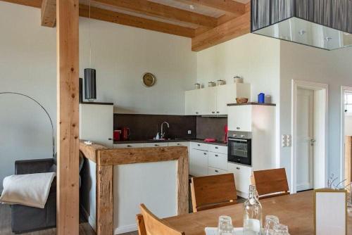 a kitchen with a table and a dining room at Gut-Royum-Haferkiste in Brodersby