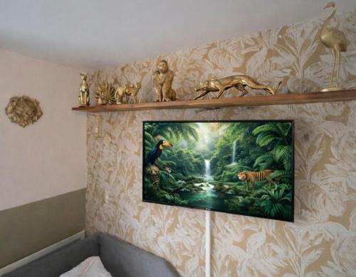 a painting of a forest on a wall at Jungle Duplex with pool 5 min Disneyland in Serris