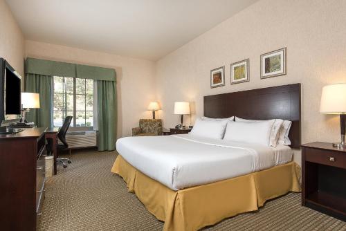 a hotel room with a large bed and a television at Holiday Inn Express Haskell-Wayne Area by IHG in Haskell