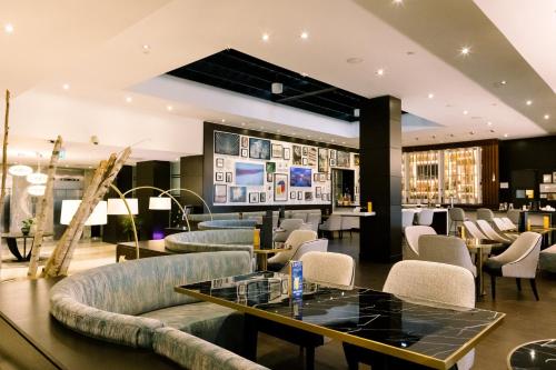 a lobby with couches and a table and chairs at Crowne Plaza Toronto - North York by IHG in Toronto