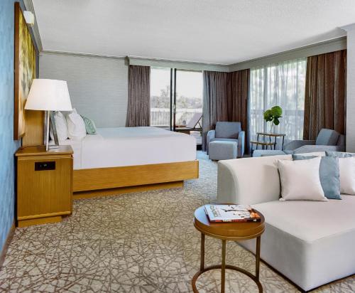 a hotel room with a bed and a couch at Crowne Plaza Toronto - North York by IHG in Toronto