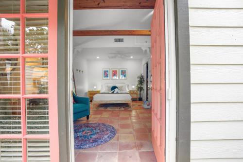 a door leading into a bedroom with a bed at Be A Nomad - Pool Access Studio Apartment - Jacksonville Beach Couples in Jacksonville Beach