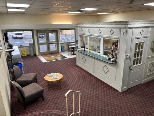 an office with a waiting area with chairs and a table at Economy Inn of Reading in Reading