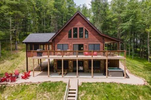 a large wooden house with a large deck at Lakefront Escape by Railey Vacations in Swanton
