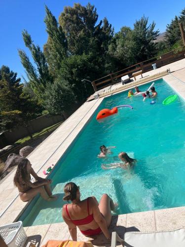 a group of people playing in a swimming pool at Altos del Cordón in Comodoro Rivadavia