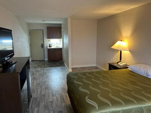 a hotel room with a bed and a television at Economy Inn of Reading in Reading