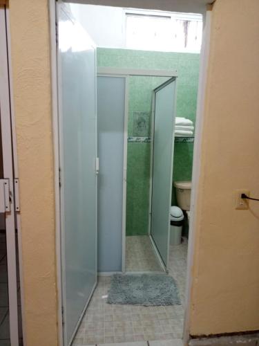 a glass shower in a bathroom with a toilet at Casa Amelia in San Blas