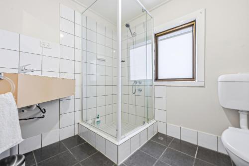 a bathroom with a shower and a toilet at Cottage on Carson in Geraldton
