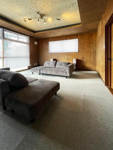 a large living room with two couches and a window at 台町Arun別邸 in Abashiri