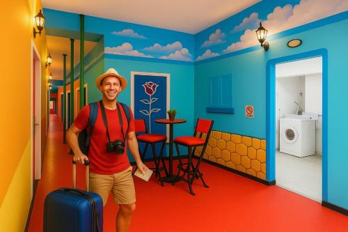 a man standing in a room with a suitcase at Hotel Fundidora - Regiotitlan in Monterrey