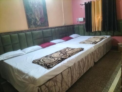 a large bed in a room with at Shri Radha Raman Ji Seva Sadan in Mathura