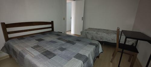 a bedroom with a bed and a desk in it at Bem te vi in Niterói