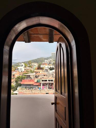 an open door with a view of a city at Mocali in Puerto Vallarta