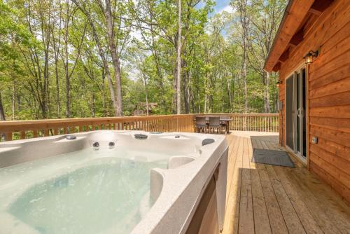 a jacuzzi tub on the deck of a cabin at Lighthearted Lodge by Railey Vacations in Swanton