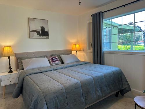 a bedroom with a bed and a large window at Suite E with 2-bedroom in Sacramento