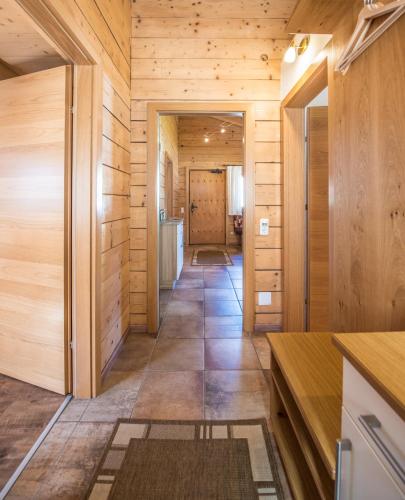 a hallway of a house with wooden walls and floors at Samerhäusl in Bruck an der Großglocknerstraße