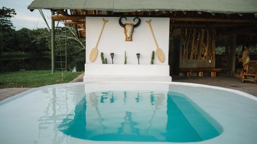 a table with utensils and a skull on a wall at WISIRARE ECOLODGE - Luxury experience in Yopal