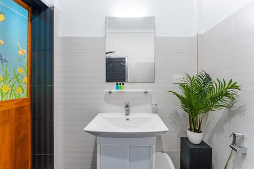 a bathroom with a sink and a toilet and a mirror at The One Hikkaduwa in Hikkaduwa