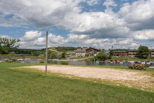 a park with a bench next to a river at Ski Harbor #32 by Railey Vacations in McHenry