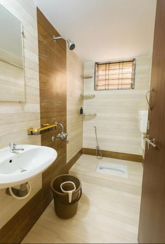a bathroom with a sink and a toilet at Heartistry in Jabalpur