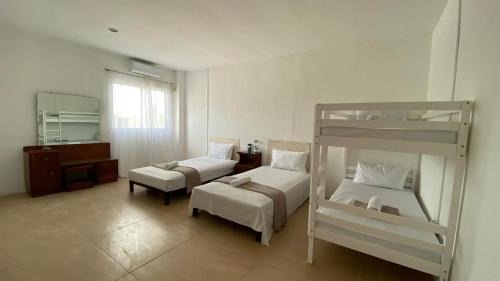 a bedroom with two bunk beds and a chair at Ciano's Hostel Cebu in Cebu City